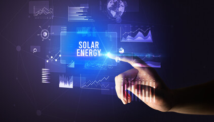 Hand touching SOLAR ENERGY inscription, new business technology concept