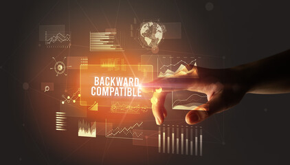 Hand touching BACKWARD COMPATIBLE inscription, new business technology concept