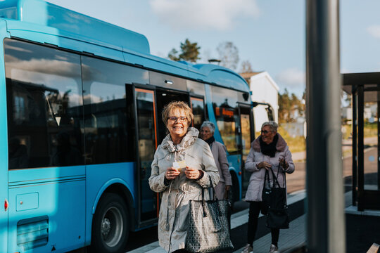 Smiling woman at bus station