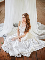 Bride in a white tent in a loft studio