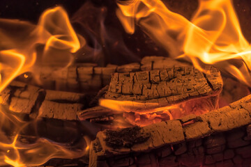 A blazing fire in the dark. Inflammation of firewood in the fire. A bright burning flames. Sparks...
