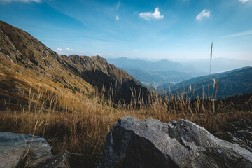 a rocky mountain with a valley below