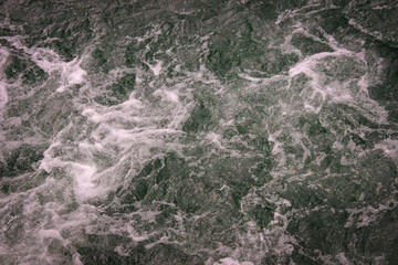 Waves on the water of the lake that appeared after the motorboat