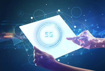Hand holdig futuristic tablet with 5G inscription, modern technology concept