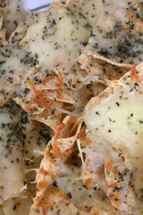 triangle nachos with hot cheese sauce as snack mexican food