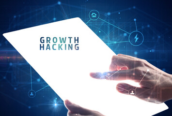 Holding futuristic tablet with GROWTH HACKING inscription, cyber security concept