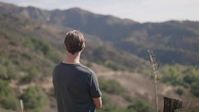 Contemplative man in rugged mountain landscape