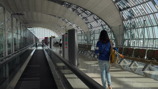 woman walking to the airport gate to board airplane