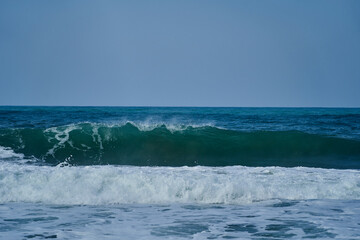 Obraz premium waves crushing in on the beach of the shoreline at Tayrona national park on the atlantic coast of Colombia in caribbean, South America