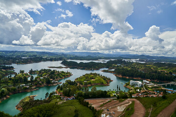 View of Guatape from the top of El Penon onto the artificial lake with its turquoise water and lagoons