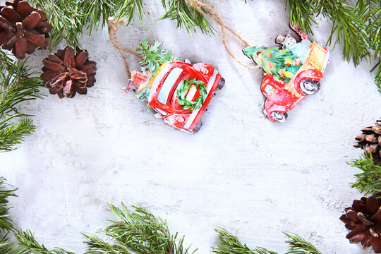 Toys made of wood and pine cones on a light background. Pine or spruce branches. The concept of New year or Christmas. Christmas card. Flat layout.Handmade Christmas tree decorations.