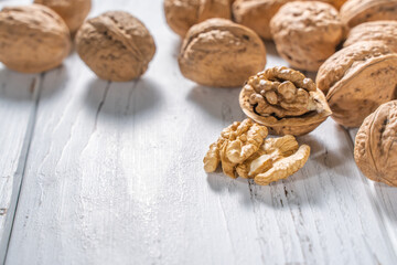 Walnuts kernels on white wooden desk, stock photo