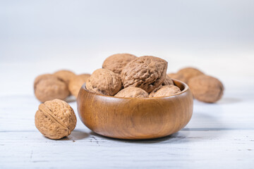 Walnuts kernels on white wooden desk, stock photo
