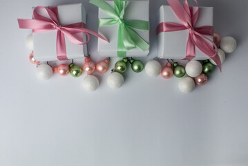 Obraz na płótnie Canvas White gifts with pastel mint and pink ribbons. Set of gift box isolated on white background.Christmas gift boxes on white background. Beautiful Christmas background with shiny balls and ribbons.