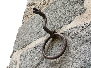 snake on a stone, Old iron snake shaped hanging on the wall.