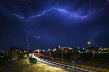 Weather, Lightning thunder storm over city in blue night.