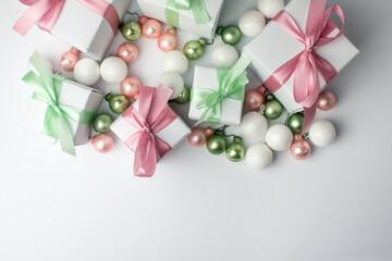 White gifts with pastel mint and pink ribbons. Set of gift box isolated on white background.Christmas gift boxes on white background. Beautiful Christmas background with shiny balls and ribbons.