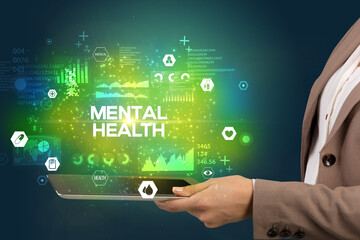 Close-up of a touchscreen with MENTAL HEALTH inscription, medical concept