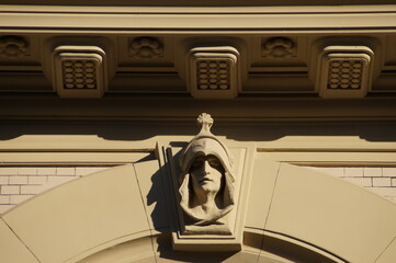 beige bas-relief in the form of a head in a helmet in a classic style