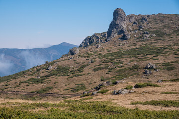 Fototapeta na wymiar Babin zub (The Grandmather's tooth) on Old mountain, which is the most beautiful peak of Stara planina ( Balkan mountains). The impressive and big striking rocks and dense plants on the top. Serbia