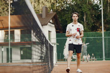 Fototapeta na wymiar Great day to play Cheerful young man in t-shirt. Guy holding tennis racket and ball.
