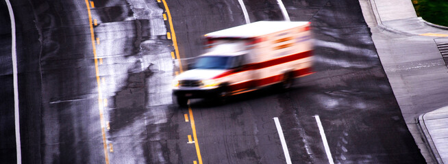 Ambulance Speeding Down Roadway Blurred