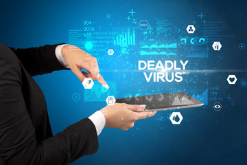 Close-up of a touchscreen with DEADLY VIRUS inscription, medical concept