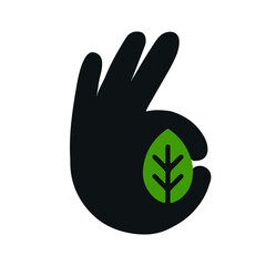 hand holds a leaf in the shape of an okay sign
