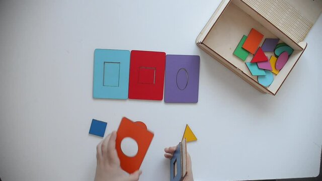 Learning colors and shapes. Children's wooden toy. The child collects a sorter. Educational logic toys for kid's. Kindergarten educational toys, Cognitive skills, Learn Through Play tools concept.