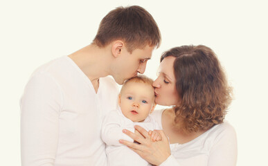 Family portrait of happy mother, father kissing their baby over a white background