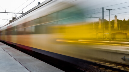 Naklejka premium Train passing at high-speed in the station, arriving or departing, metro station