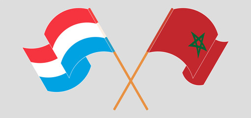 Crossed and waving flags of Luxembourg and Morocco
