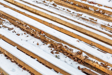 Heap of long wooden boards for the construction and improvement of the yard