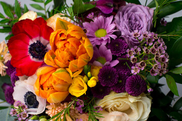 Colorful bouquet of fresh spring flowers on white background. Colorful blooming flowers: tulips, peonies, roses in a spring bouquet. Background, place for text. Wedding bouquet.