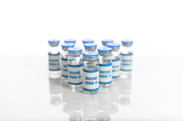 Group of blue bottles of covid vaccine isolated on white background. Scientific confronting of outspread of coronavirus pandemic