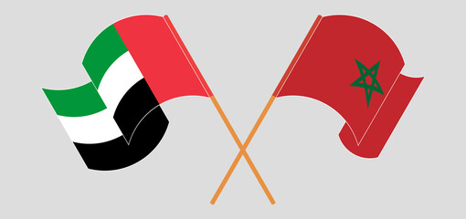 Crossed and waving flags of the United Arab Emirates and Morocco