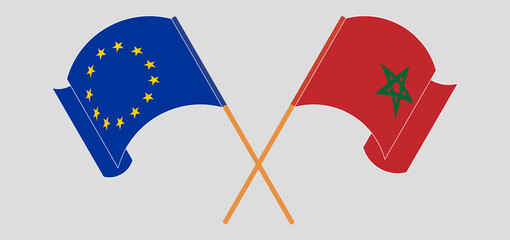 Crossed and waving flags of the European Union and Morocco
