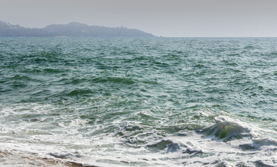 Rugged chaotic moving waved of ocean surface. Clouded extreme seaside far away. Dangerous sea depth for navy background. Heavy stormy massive tide on the coast. Deep rippled vintage severe surf beach
