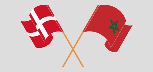 Crossed and waving flags of Denmark and Morocco