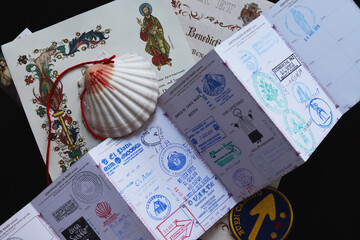Personal belongings of a pilgrim - a pilgrim's passport with seals, a shell, a certificate of completion of the pilgrimage - obrazy, fototapety, plakaty