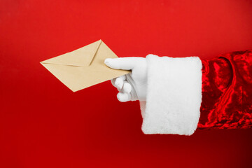Santa Claus hand hold craft envelope with letter, sending post card. Christmas mail. Wish list