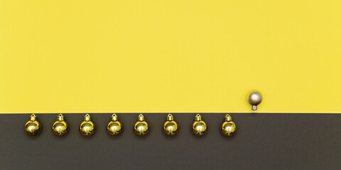 Christmas banner in colors of the 2021 year Illuminating and gray. Christmas border flat lay with gold balls and one silver in a line on yellow and gray background.