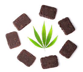 Green hemp leaf on white isolated background in a circle of chocolate cookies in a rectangular shape