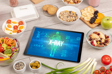 X-RAY concept in tablet with fruits, top view