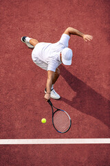 Tennis player hitting ball - obrazy, fototapety, plakaty