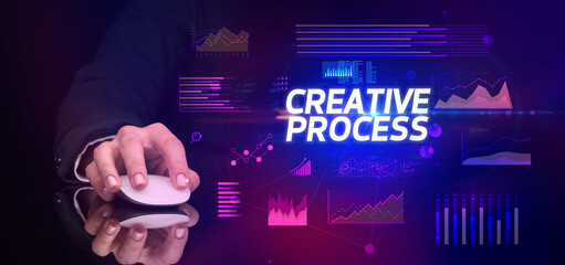 hand holding wireless peripheral with CREATIVE PROCESS inscription, cyber business concept