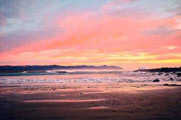 Fototapeta na wymiar Sunset surf warning, mega waves, beautiful sky, pure power. 