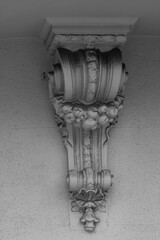 Elements of architectural decorations of buildings, a beam, a bracket under the balcony and a column, plaster patterns and stucco. On the streets in Catalonia, public places. © Kozlik_mozlik