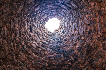 Looking up through the opening at the top of an historic beehive shape charcoal ovens constructed during the 19 century as part of silver mining in the ghost town, Ward Charcoal Ovens, Nevada