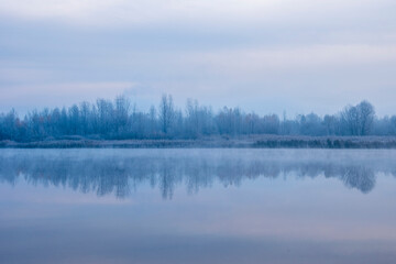 Fototapeta premium Ukraine, Kyiv - 30 November 2020: Nebrezh Lake at the frozen mist morning weather